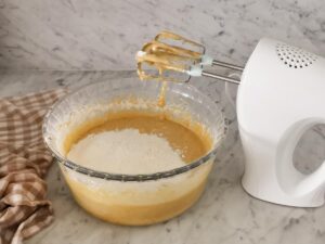 adding flour to make cake