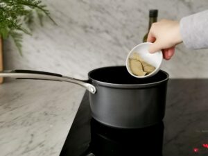 adding thyme and bay leaves to tomato sauce