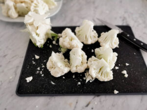 cutting cauliflower into florets for cauliflower soup