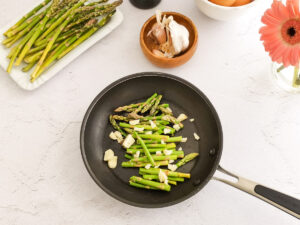 sauté asparagus and garlic in a pan