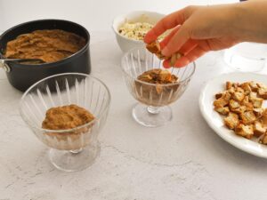 adding cantucci bites on top of chocolate pudding