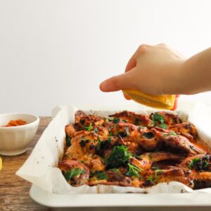 adding lemon juice on baked Italian chicken wings