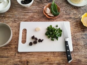 chopping basil and olives