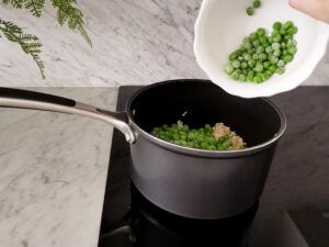 adding peas for green pea risotto