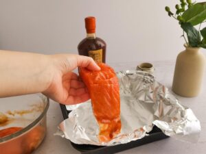 adding salmon to baking dish