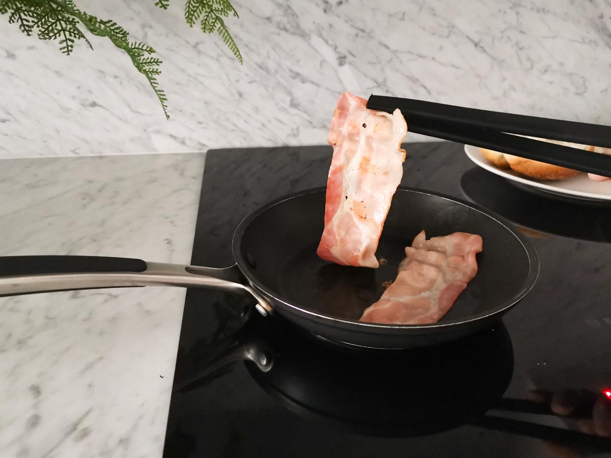crisping up the bacon in a pan