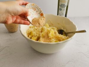 adding breadcrumbs to potatoes