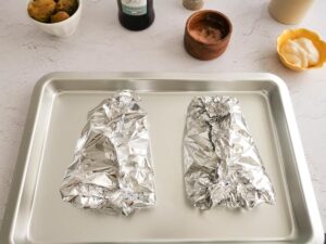 poached salmon in foil ready to bake