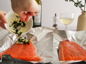 topping salmon with garlic and parsley