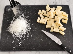 preparing hard cheeses for quattro formaggi pasta