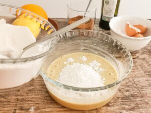 adding flour to wet ingredients for cake