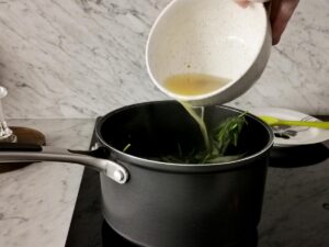 adding vegetable stock to italian sausage soup