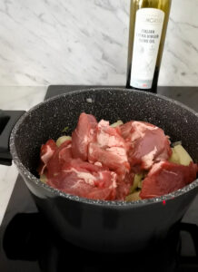 adding lamb meat to make lamb artichoke casserole