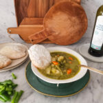 serving minestrone with pesto