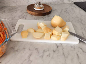 cutting smoked caciotta cheese