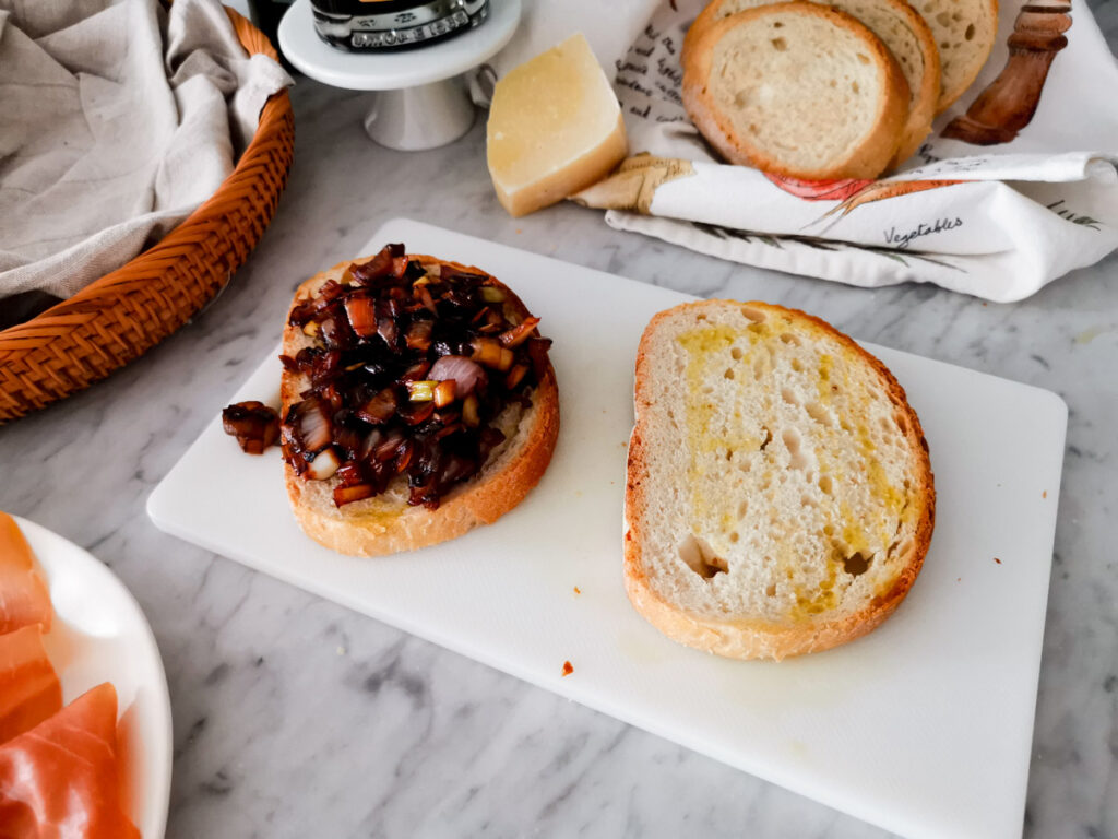 topping crostini with balsamic onion jam