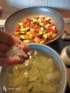 Spinach leaves pasta with salmon and courgettes