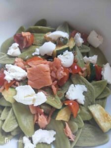 Spinach leaves pasta with salmon and courgettes