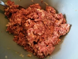 preparing meat pizza